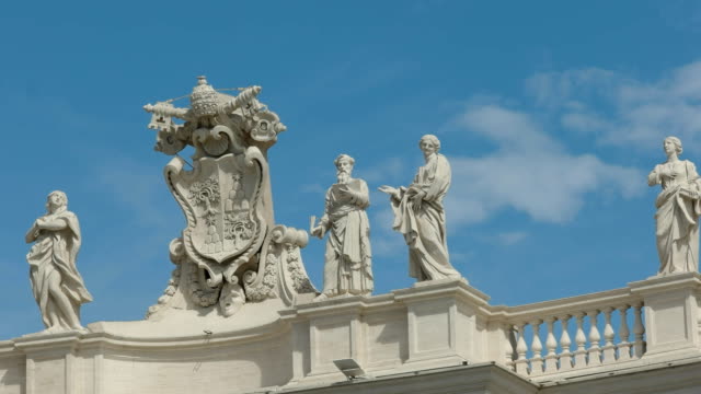 close-up-of-a-papal-crest-and-statues-in-st-peter's-square