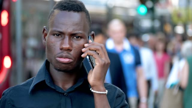 Porträt-des-jungen-schwarzen-afrikanischen-Mann-sprechen-per-Telefon-in-der-Stadt