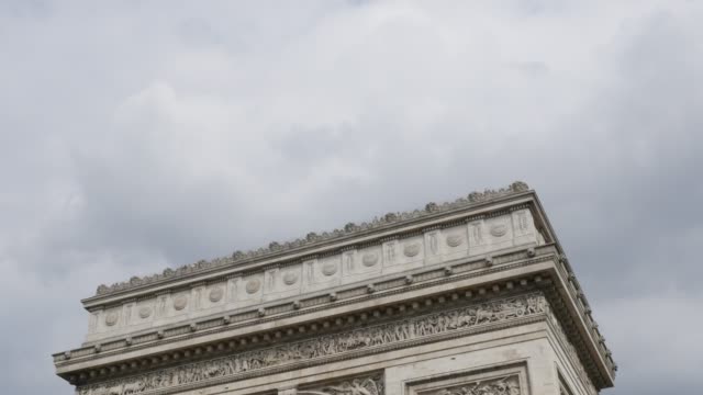 Highly-detailed-surface-of-Arch-of-Triumph-in-Paris-France-in-front-of-cloudy-sky-4K-3840X2160-30fps-UHD-tilt--footage---World-famous-Arc-de-Triomphe-de-Etoile-slow-tilting-4K-2160p-UltraHD-video
