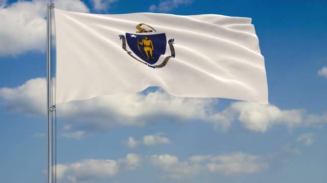 Massachusetts-State-flag-in-wind-against-cloudy-sky
