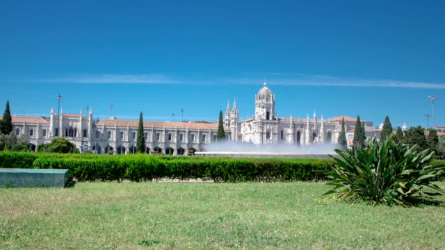 The-Jeronimos-Monastery-or-Hieronymites-Monastery-with-lawn-and-fountain-is-located-in-Lisbon,-Portugal-timelapse-hyperlapse