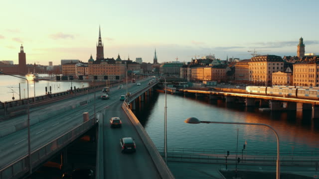 Stockholm-cityscape-at-sunset-in-4K.-Central-city-skyline,-bridges-and-traffic