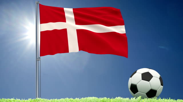 Flag-of-Denmark-fluttering-and-a-football-rolls-on-the-lawn,-3d-rendering,-4k-footage