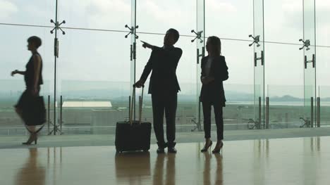 asian-businessman-and-businesswoman-talking-in-airport