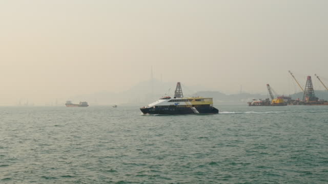 puesta-de-sol-Hong-Kong-victoria-harbour-nave-industrial-tráfico-panorama-4k-china