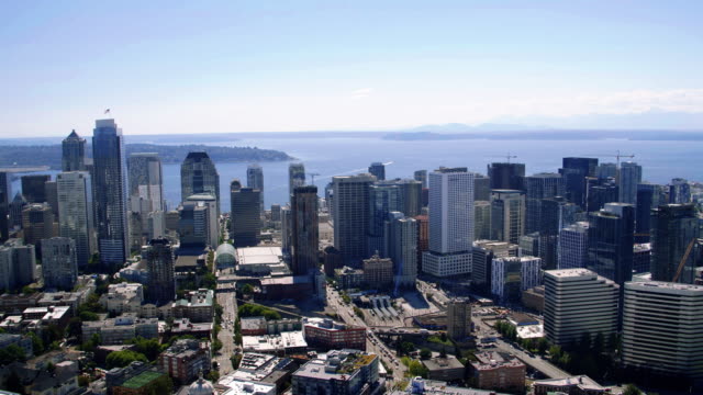 Downtown-Seattle-Waterfront-Buildings-Blue-Sky-Aerial