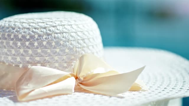 Close-up-of-elegant-white-female-sun-hat-with-winding-bow