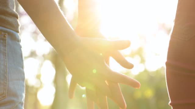 Joining-hands-together,-uniting-the-chain-from-hands-held-together-in-the-sunlight