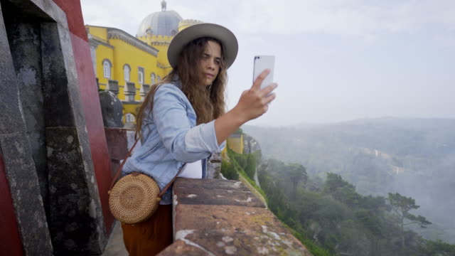 Young-woman-taking-pictures-from-palace-terrace