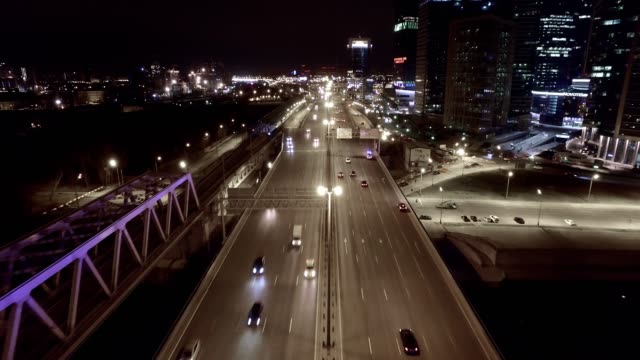 Aerial-night-highway-bridge-passing-cars