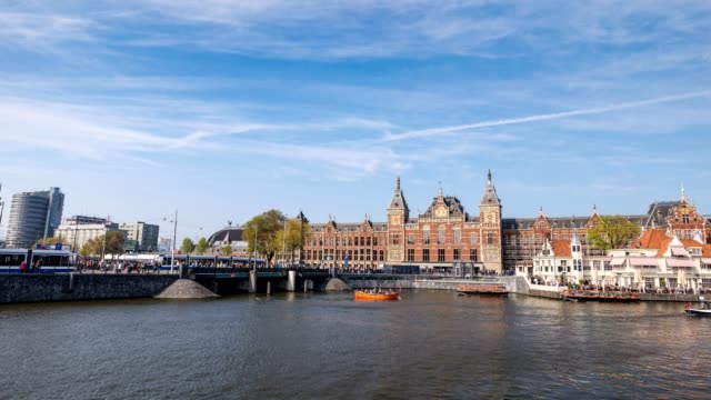 Amsterdam-city-skyline-timelapse-at-Amsterdam-Central-Station,-Amsterdam,-Netherlands,-4K-Time-Lapse