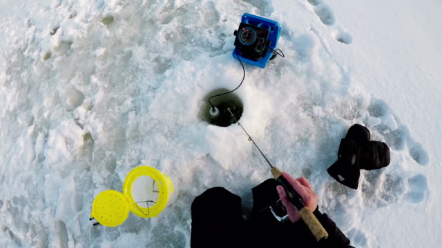 Fisherman-fishing-in-snow