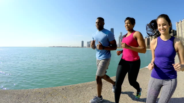 Ethnic-male-and-females-running-in-Chicago-city
