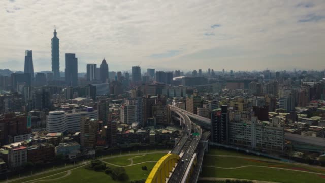 sunny-day-taipei-cityscape-river-traffic-bridge-aerial-downtown-panorama-4k-timelapse-taiwan