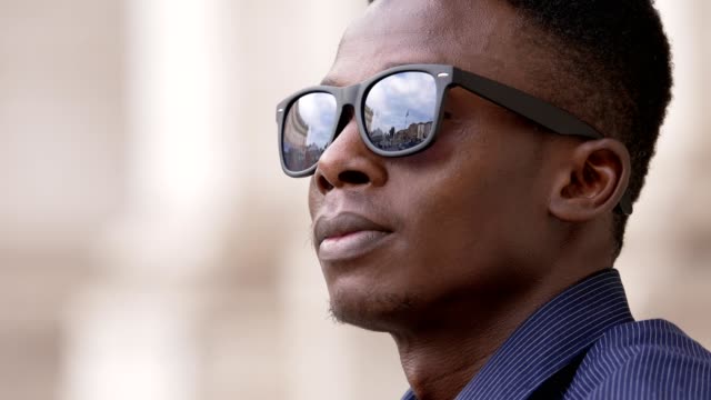 Attractive-african-man-looking-taking-off-his-sunglasses--success,confidence