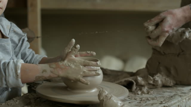 Little-Girl-Throwing-Pot-in-Pottery-Class