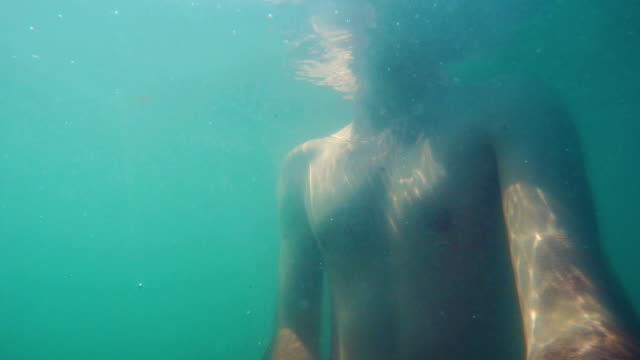 Underwater-shot-of-a-man-swimming-in-the-sea