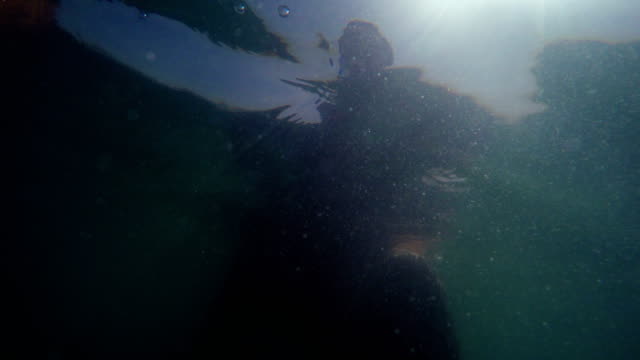Underwater-shot-of-a-man-swimming-in-the-sea