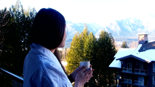 Woman-having-a-cup-of-coffee-in-balcony