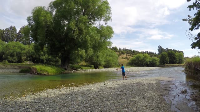 Man-fly-fishing-on-the-Mataura-River-in-southland-region-of-the-South-Island-of-New-Zealand
