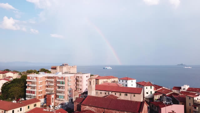 Piombino,-Italy.-Aerial-view-of-the-city,-sea,-ship-and-rainbow-at-the-sky
