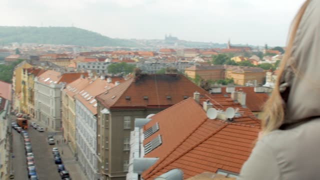 view-from-top-on-a-cozy-Prague-streets-in-cloudy-summer-day,-camera-is-turning-to-cheerful-woman