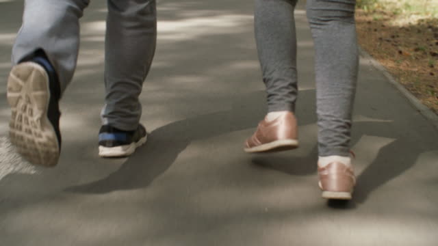 Legs-of-People-Jogging-along-Pavement