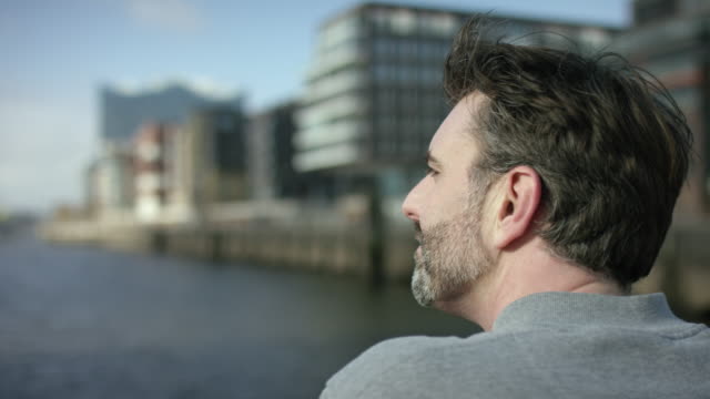 Middle-aged-men-is-looking-over-a-river-and-is-thinking-about-his-future
