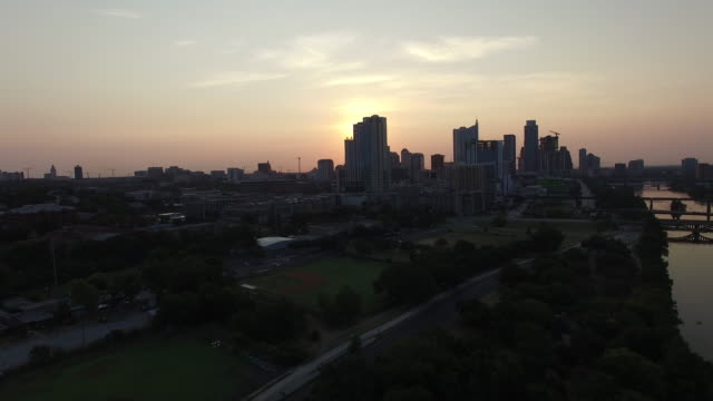 Aerial-view-of-sunset-sun-setting-over-Austin,-Texas,-USA