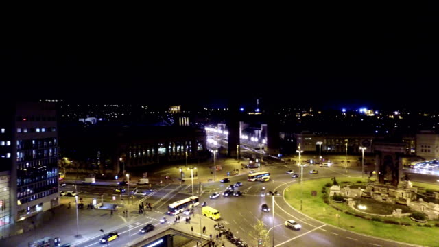 Spanish-Square-aerial-view-in-Barcelona,-This-is-the-famous-place-with-traffic-light-trails,-fountain-and-Venetian-towers,-and-National-museum-at-the-background.-Blue-sky