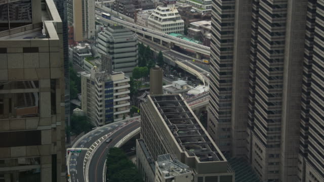Busy-Tokyo-city-highway-road-next-to-skyscrapers-cityscape-buildings