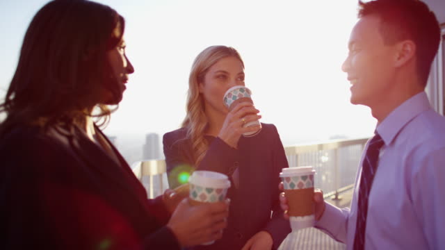 Multi-ethnic-business-managers-enjoying-coffee-on-rooftop