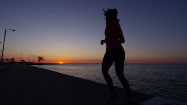 Hispanic-female-silhouette-running-at-sunrise-in-Chicago