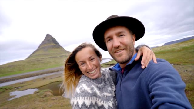 Slow-motion-Selfie-portrait-of-tourist-couple-in-Iceland-at-Kirkjufell-mountain