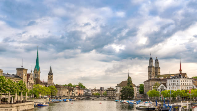 Zurich-Switzerland-time-lapse-4K,-city-skyline-timelapse-at-Limmat-River-with-Grossmunster-and-Fraumunster-Church