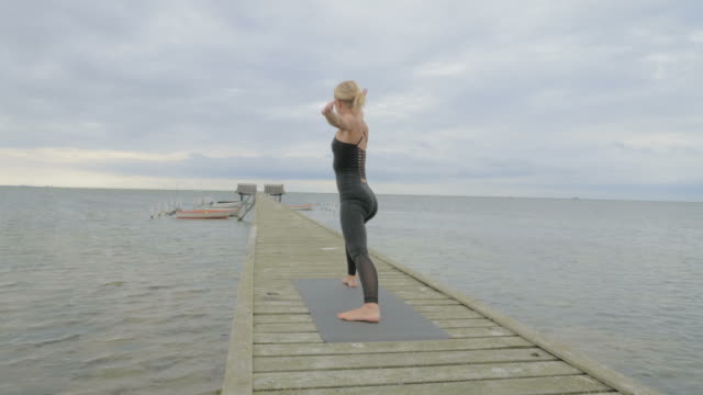 Girl-making-yoga-pose-on-bridge