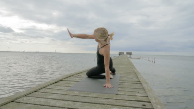 Girl-making-yoga-pose-on-bridge