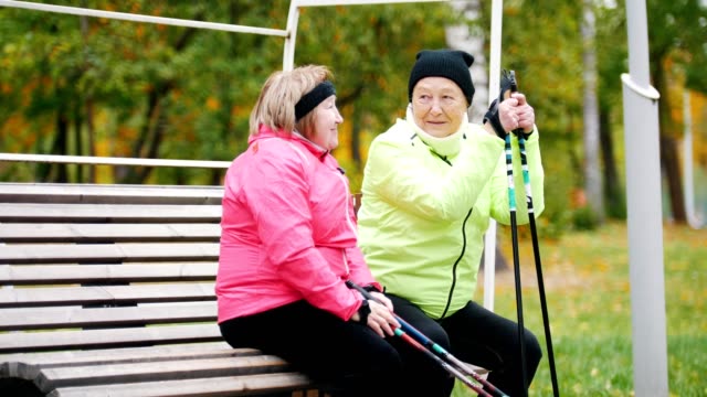 Two-mature-woman-resting-after-scandinavian-walk