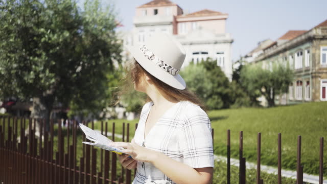 Young-girl-with-paper-map-in-modern-park