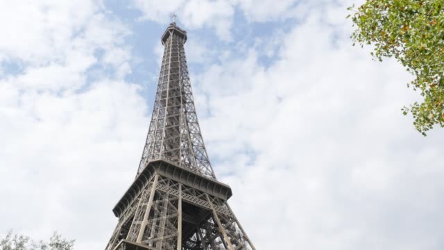 Lattice-construction-of-Eiffel-tower-and-symbol-of-France-in-front-of-cloudy-sky-4K-2160p-UltraHD-footage---Paris-and-French-recognizable-Tour-Eiffel-by-the-day-4K-3840X2160-30fps-UHD-video