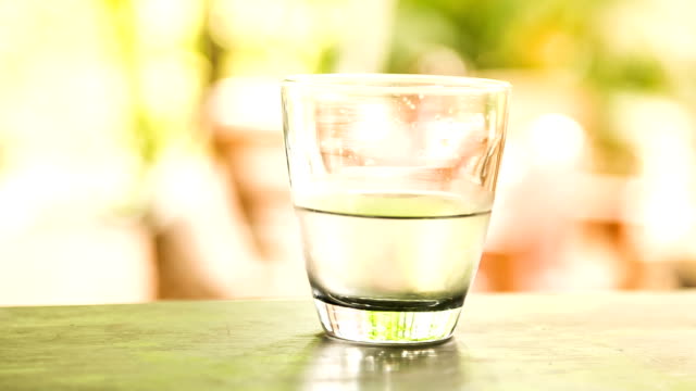 glass-of-water-with-sunny-nature-background