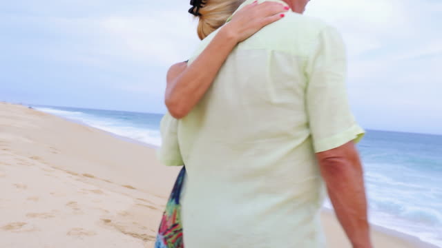 An-older-couple-looking-out-at-the-ocean