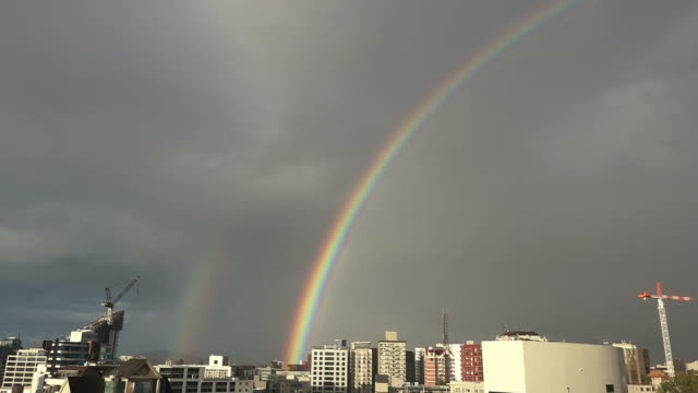 Regenbogen-über-die-skyline-der-Stadt