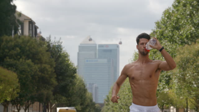 A-young-man-running-though-London-with-City-of-London-behind-him.