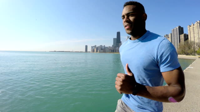 African-American-male-running-along-Chicago-city-shoreline