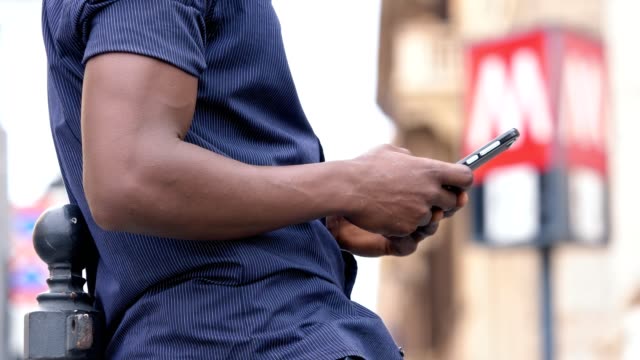 close-up-on-American-african-man's-hands-typing-on-smartphone--technology,-communication