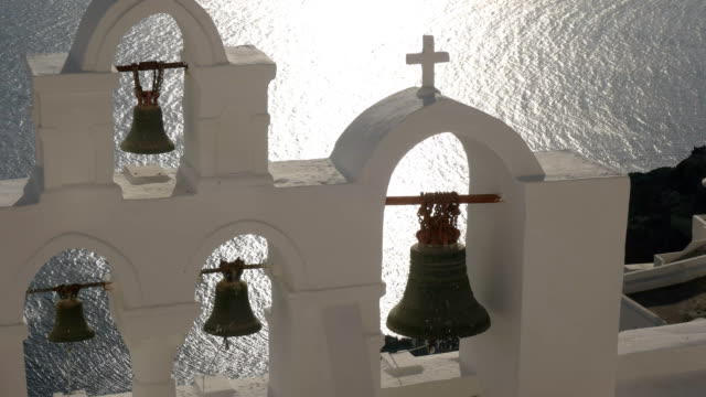close-up-pan-of-four-church-bells-at-oia,-santorini
