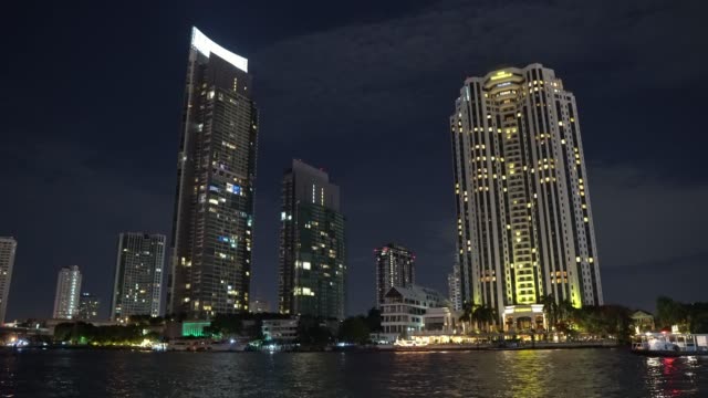 business-center-at-night,-high-rise-buildings-on-the-river-bank.-skyscrapers