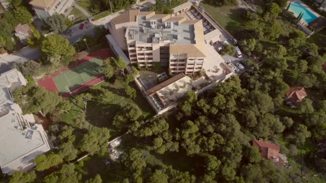 Aerial-view-of-a-residential-building,-surrounded-by-trees-in-Greece.