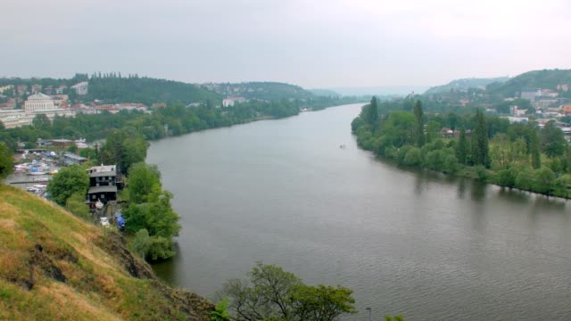 top-view-on-wide-european-river-and-outskirts-of-old-city-in-cloudy-weather